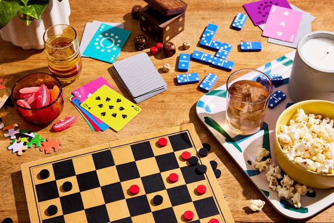 Board game meetup table with cards, checkers, snacks and drinks